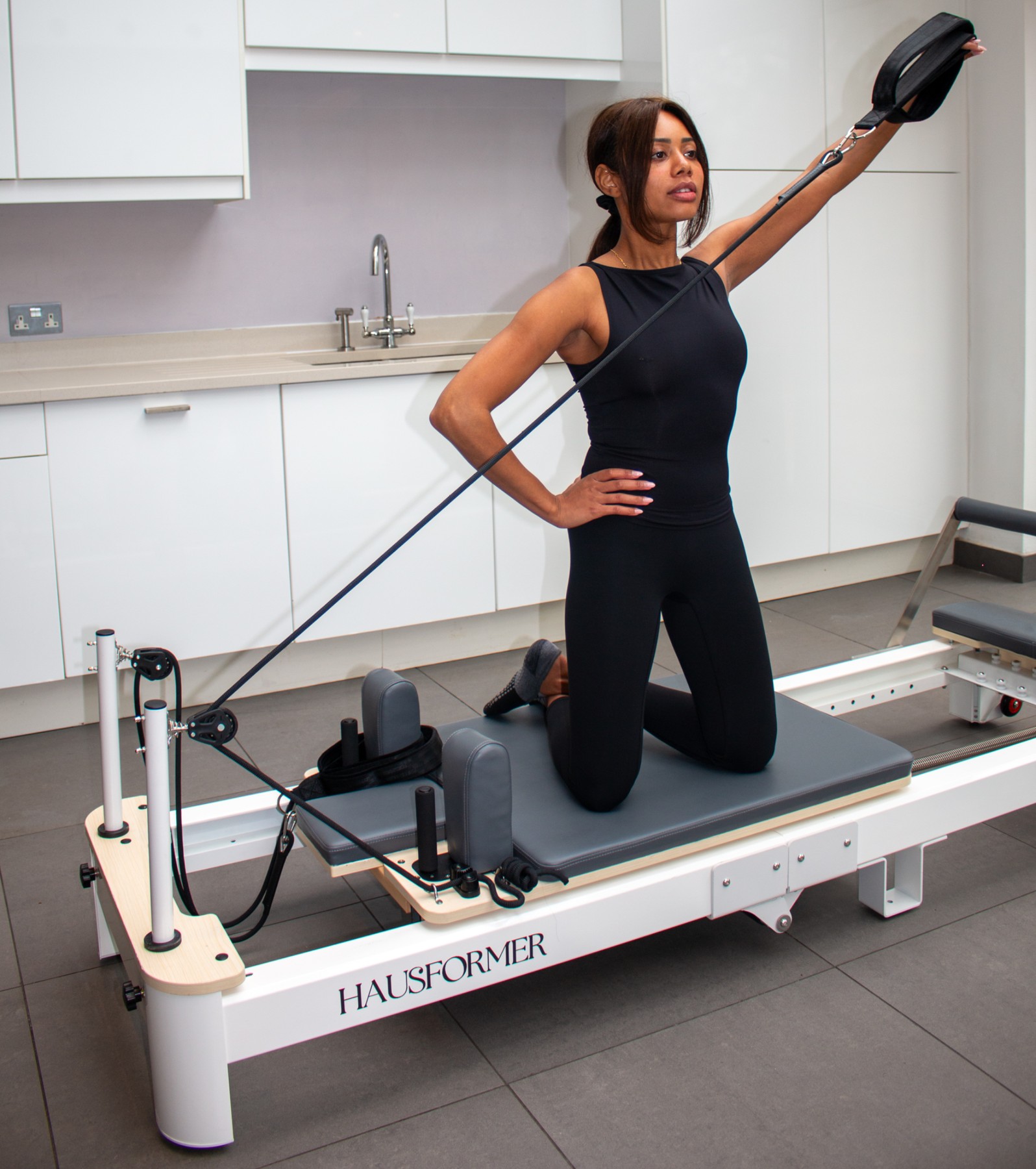 Reformer Pilates exercise on a Hausformer